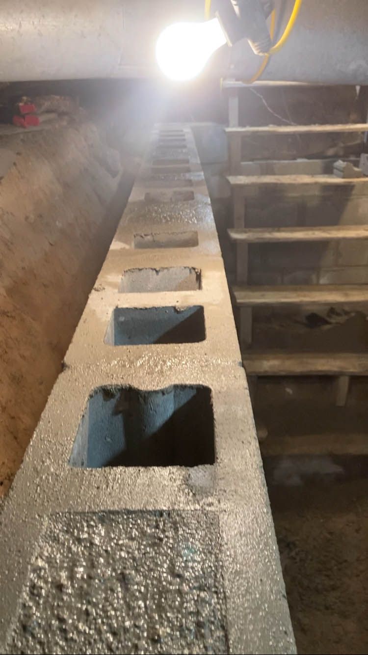 A row of concrete blocks sitting next to each other in a basement.
