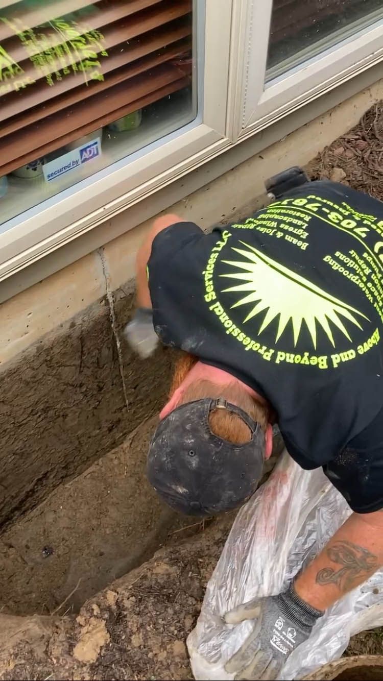 A man in a black shirt is laying on the ground.