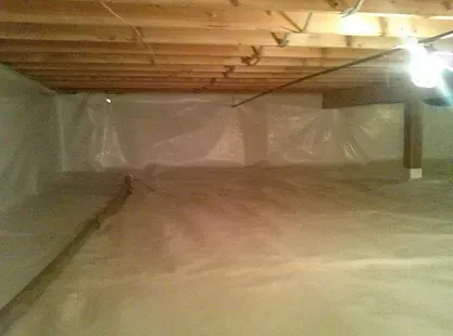 A basement filled with plastic and wooden beams.