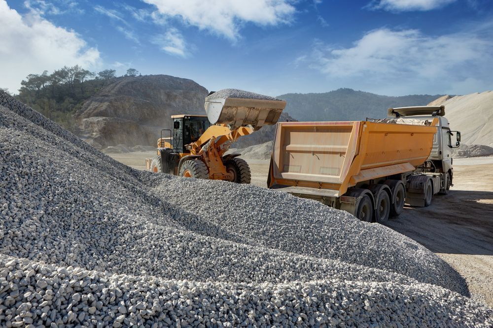 A Dump Truck Is Being Loaded With Gravel At A Construction Site — Twin Towns Sand & Gravel In Tweed Heads South, NSW