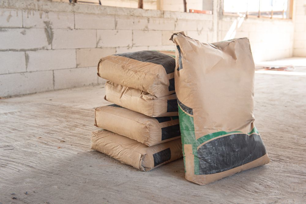 A Pile Of Bags Of Cement Are Stacked On Top Of Each Other On The Floor — Twin Towns Sand & Gravel In Tweed Heads South, NSW