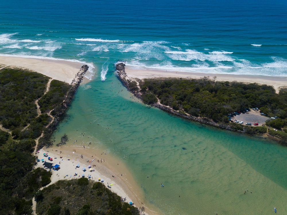 An Aerial View Of A River Flowing Into The Ocean Next To A Beach — Twin Towns Sand & Gravel In Pottsville, NSW