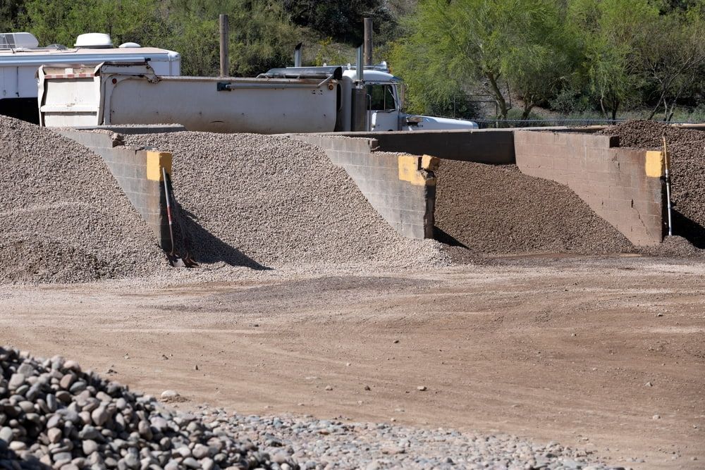 A pile of gravel is sitting on top of a dirt field — Twin Towns Sand & Gravel In Tweed Coast, NSW