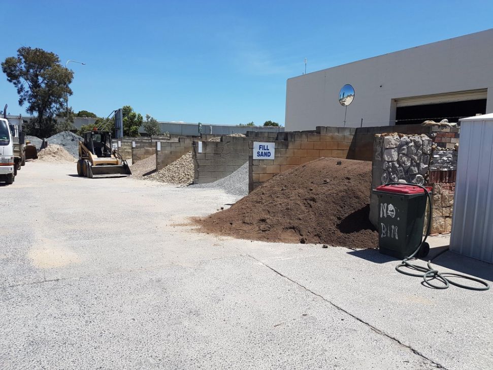 A Large Pile Of Dirt Is Sitting In Front Of A Building — Twin Towns Sand & Gravel In Tweed Heads South, NSW