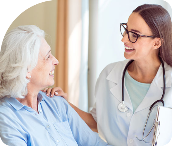 Doctor smiling and talking with a patient in a bright clinic, wearing a white coat and stethoscope.