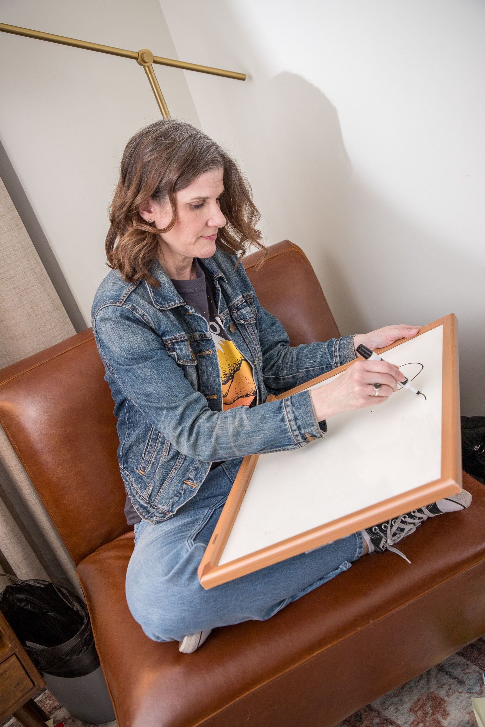 Susan Kelley writes on a whiteboard during a consultation for individual therapy in Noblesville, Indiana