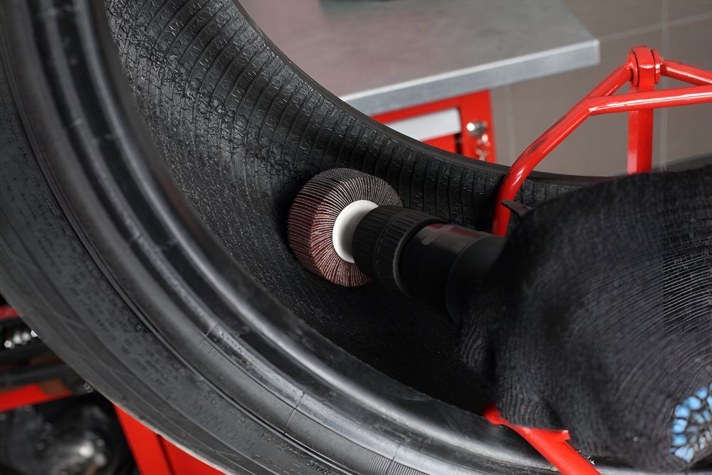 A Person is Grinding a Tire — High Grade Tyre and Mechanical in Toowoomba City, QLD