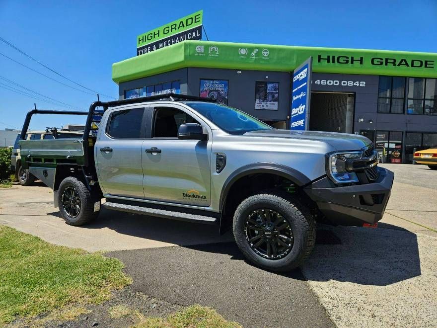 A Silver Truck Parked in Front of a Building — High Grade Tyre and Mechanical in Toowoomba City, QLD