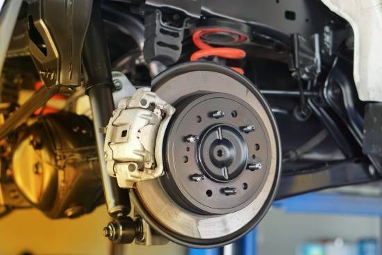 A Close Up of a Car 's Brake System on a Lift — High Grade Tyre and Mechanical in Toowoomba City, QLD