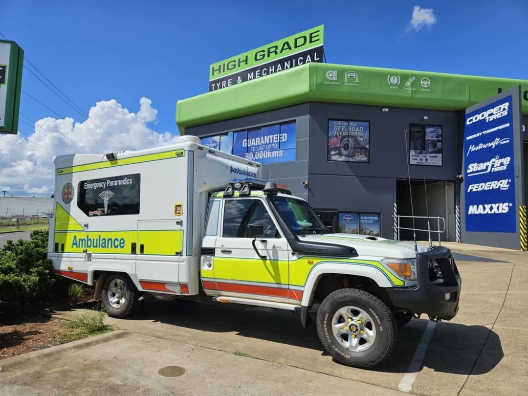 A Person is Working on a Car Battery With a Wrench — High Grade Tyre and Mechanical in Toowoomba City, QLD