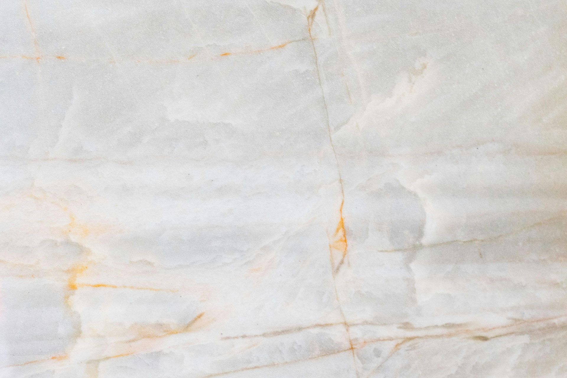 White marble with gold and gray veining.