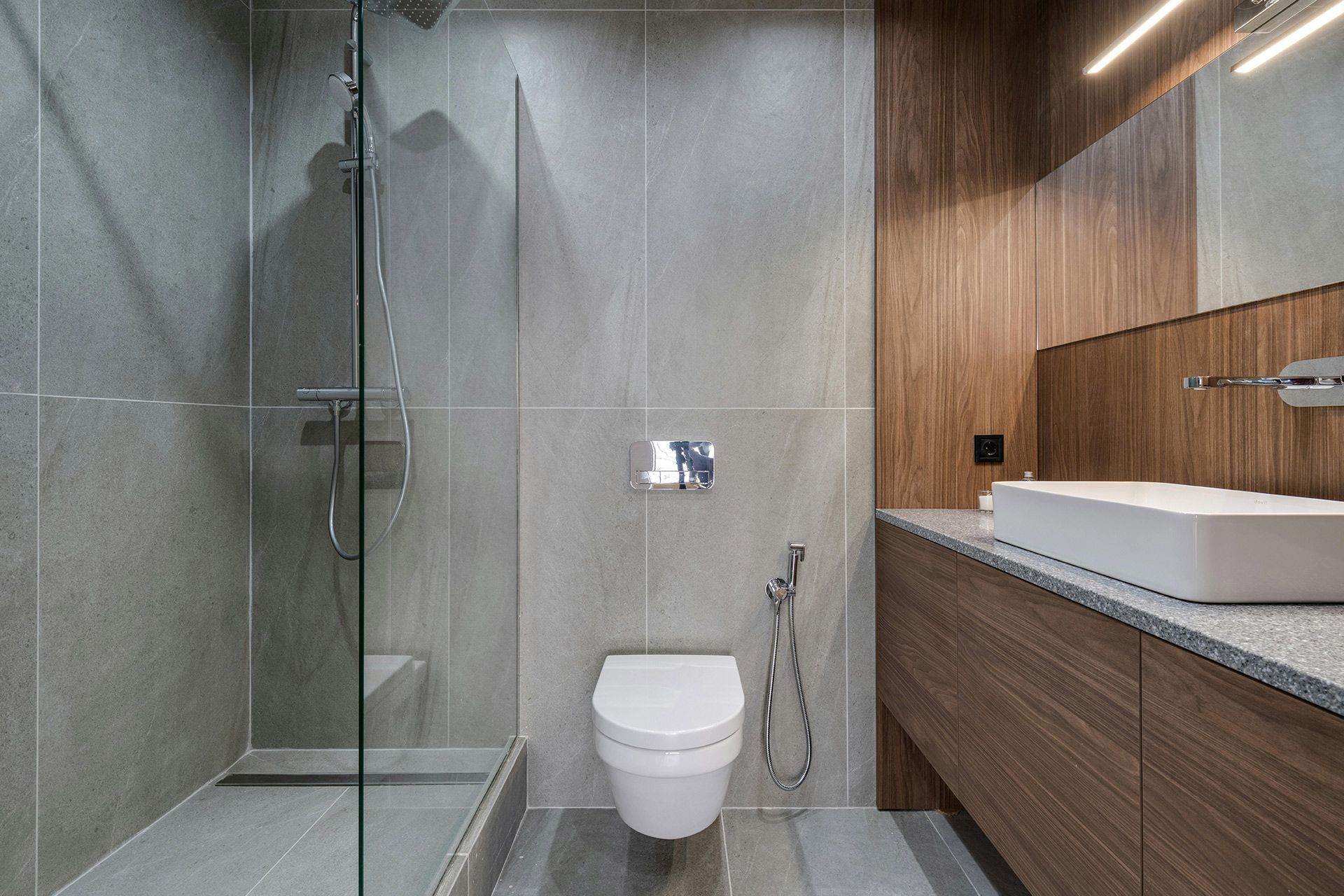 Modern walk in shower with floor to ceiling large format tile and glass enclosure in Lakewood Ohio.