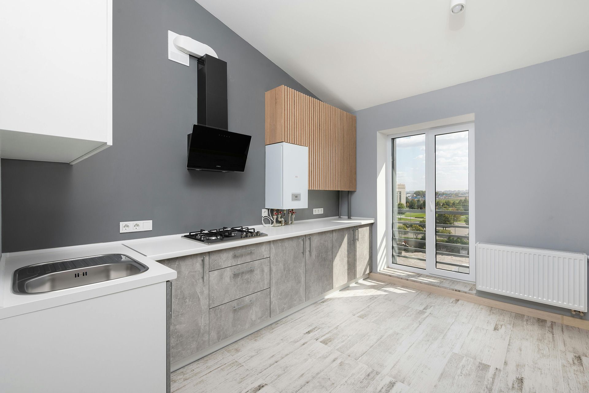 Light porcelain floor tile installed across a modern residential kitchen in Lakewood Ohio.