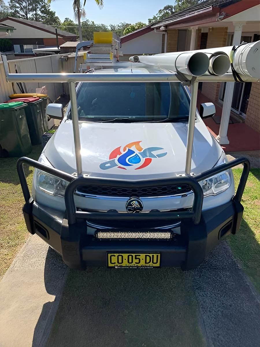 A White Truck Is Parked In Front Of A House — Richardson Plumbing & Gas Service In Port Macquarie, NSW