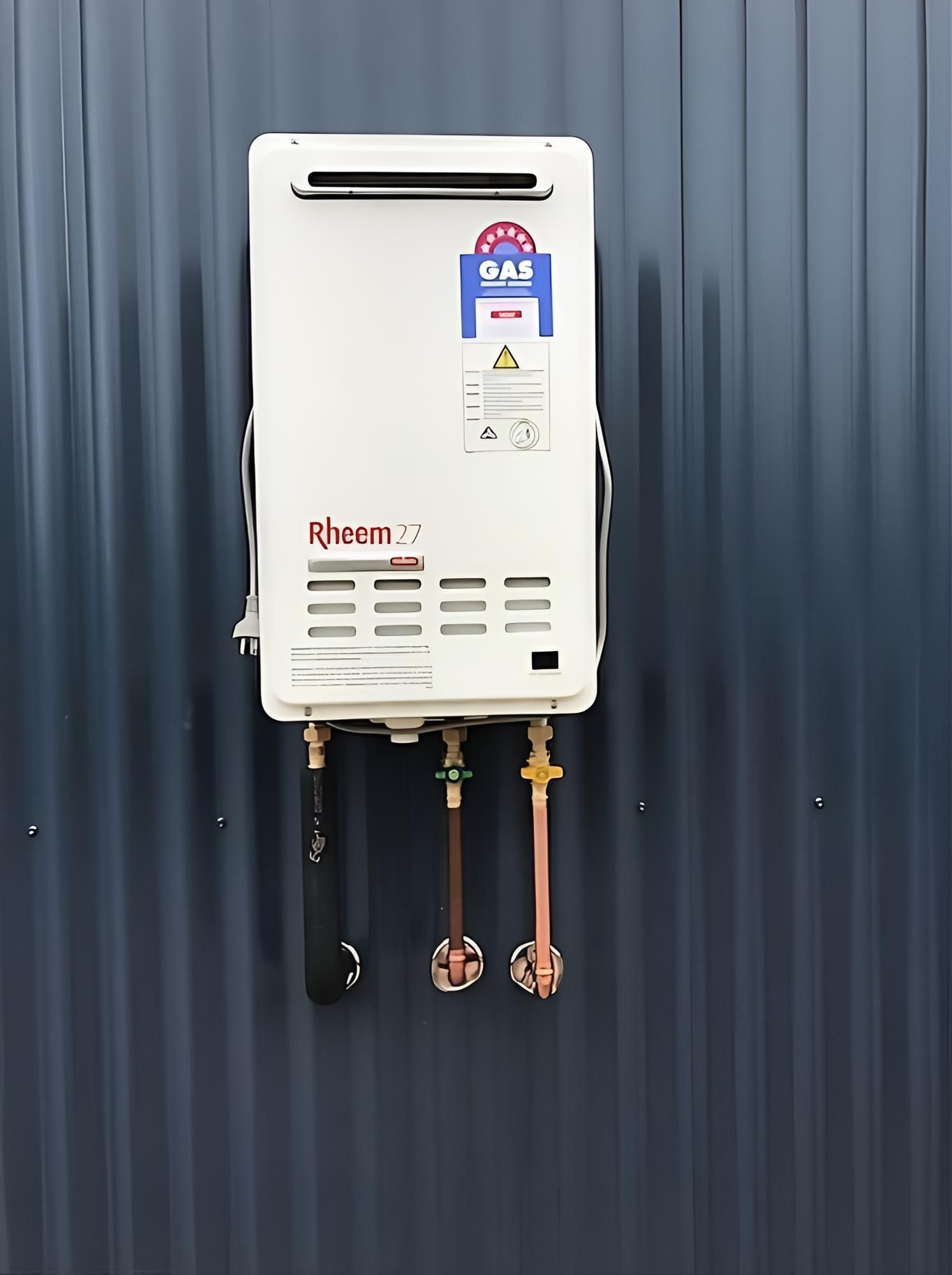 A Water Heater Is Hanging On A Black Wall — Richardson Plumbing & Gas Service In Port Macquarie, NSW