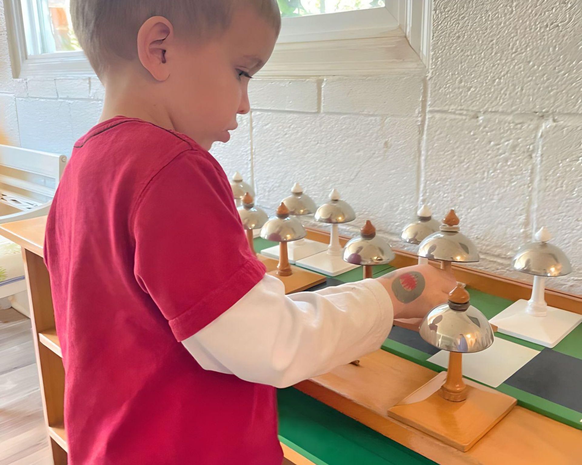 Children working with Montessori music materials
