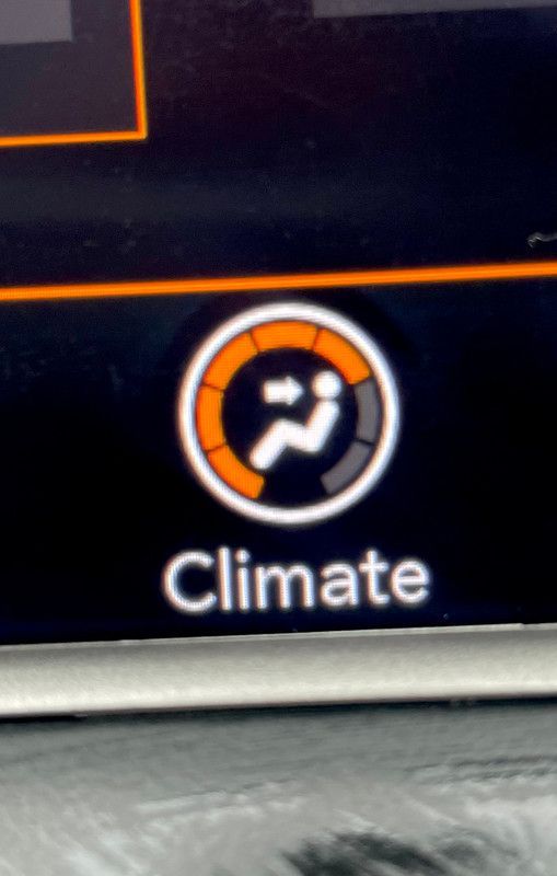 Car climate control icon; circular dial with arrows, orange and gray, labeled