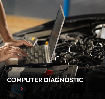 Mechanic using a laptop to diagnose a car engine in a garage. Computer diagnostic service offered.