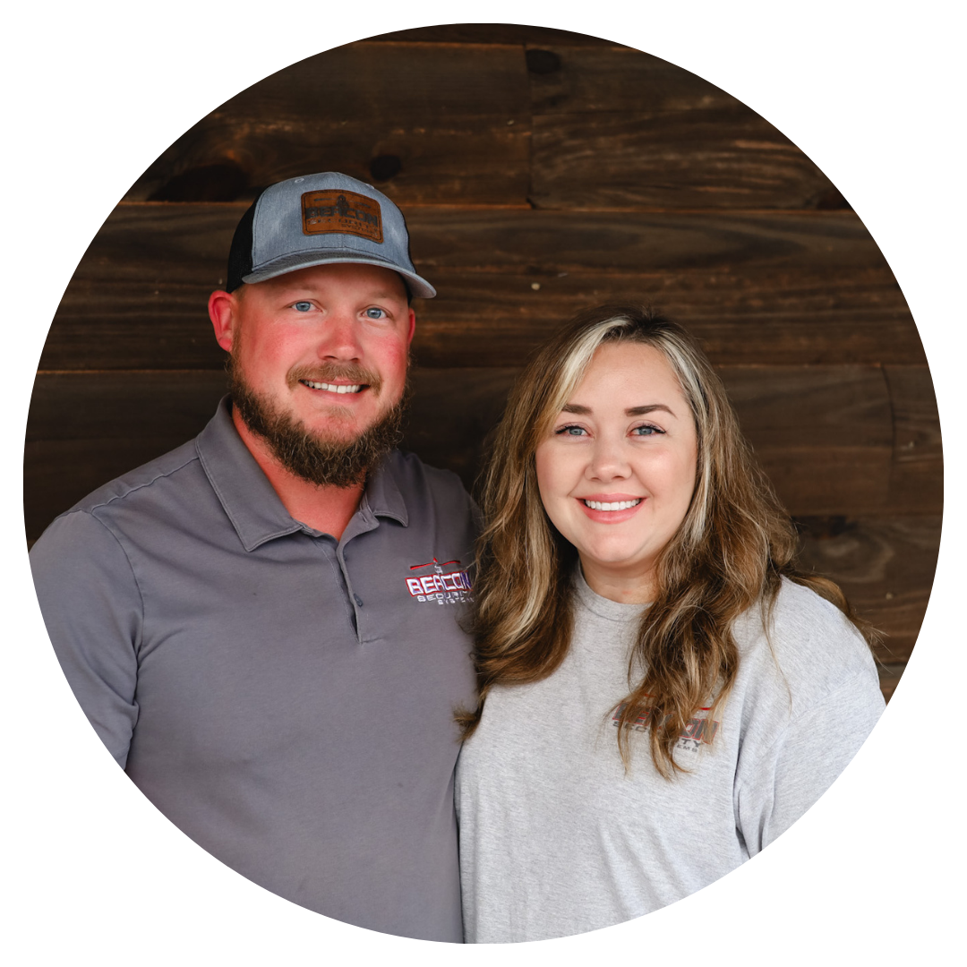 A man and a woman are posing for a picture in front of a wooden wall.