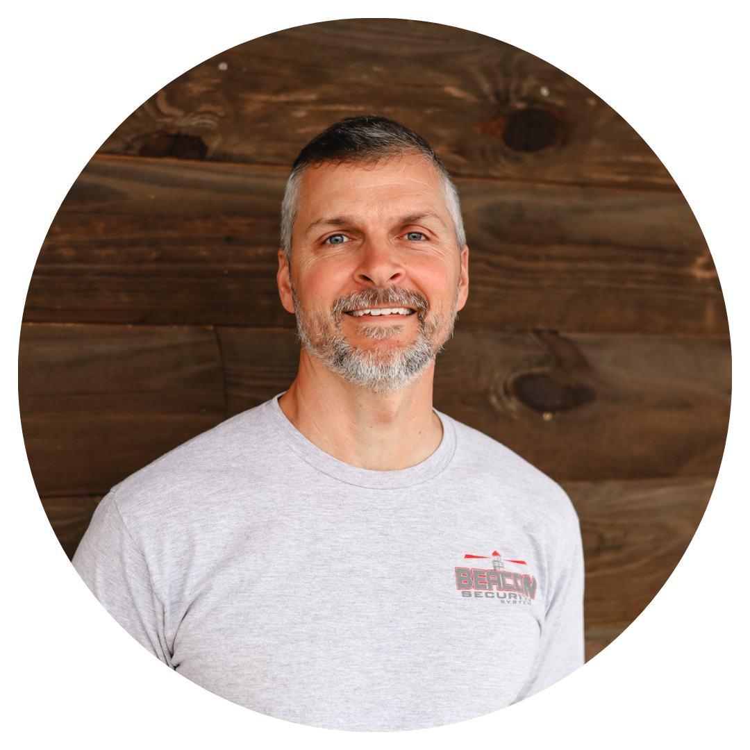 A man with a beard is wearing a grey shirt