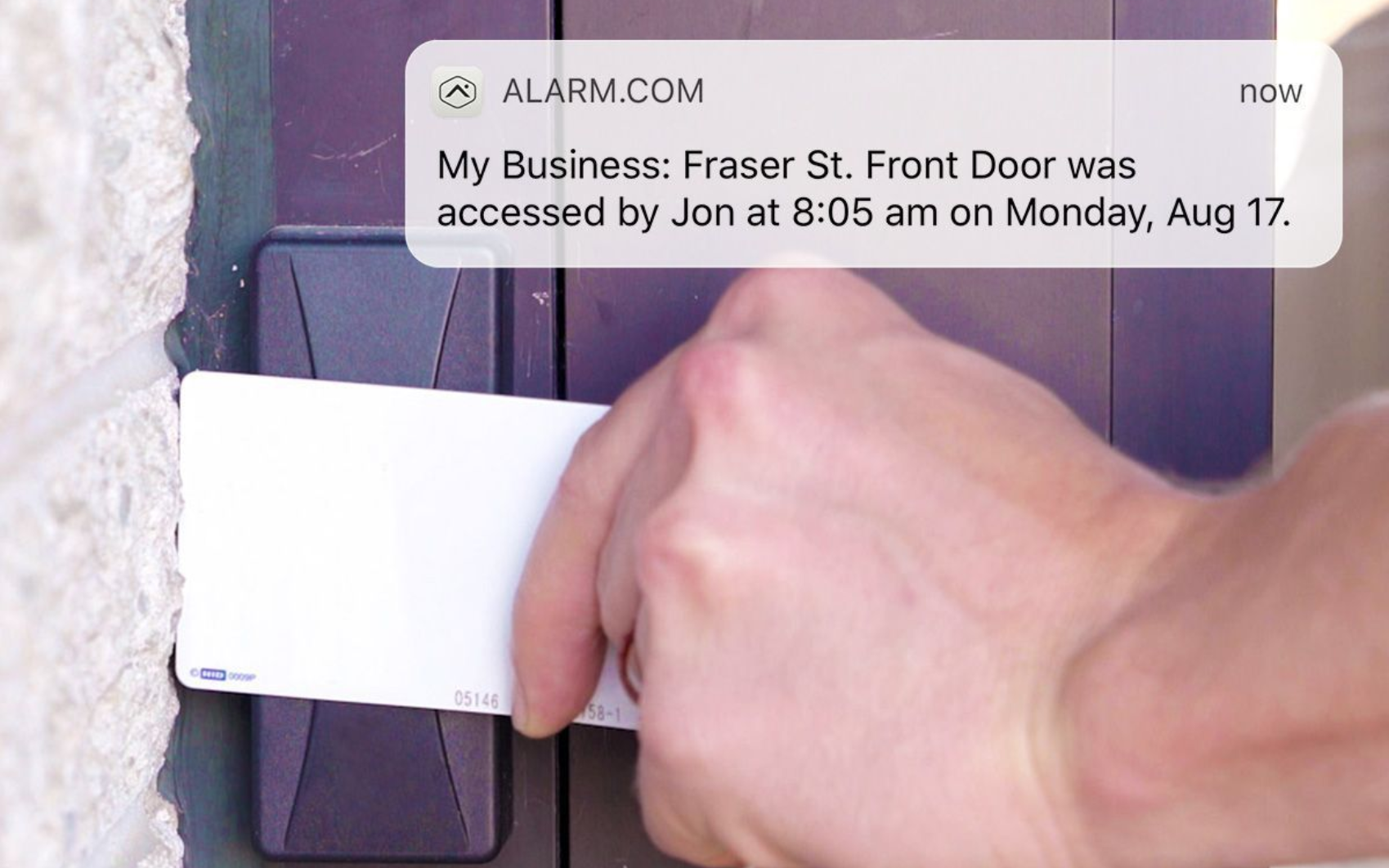 Employee using a keycard access control system to enter a commercial building with security alerts