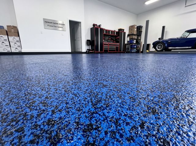 Blue speckled garage floor with a tool storage rack and a blue car parked inside