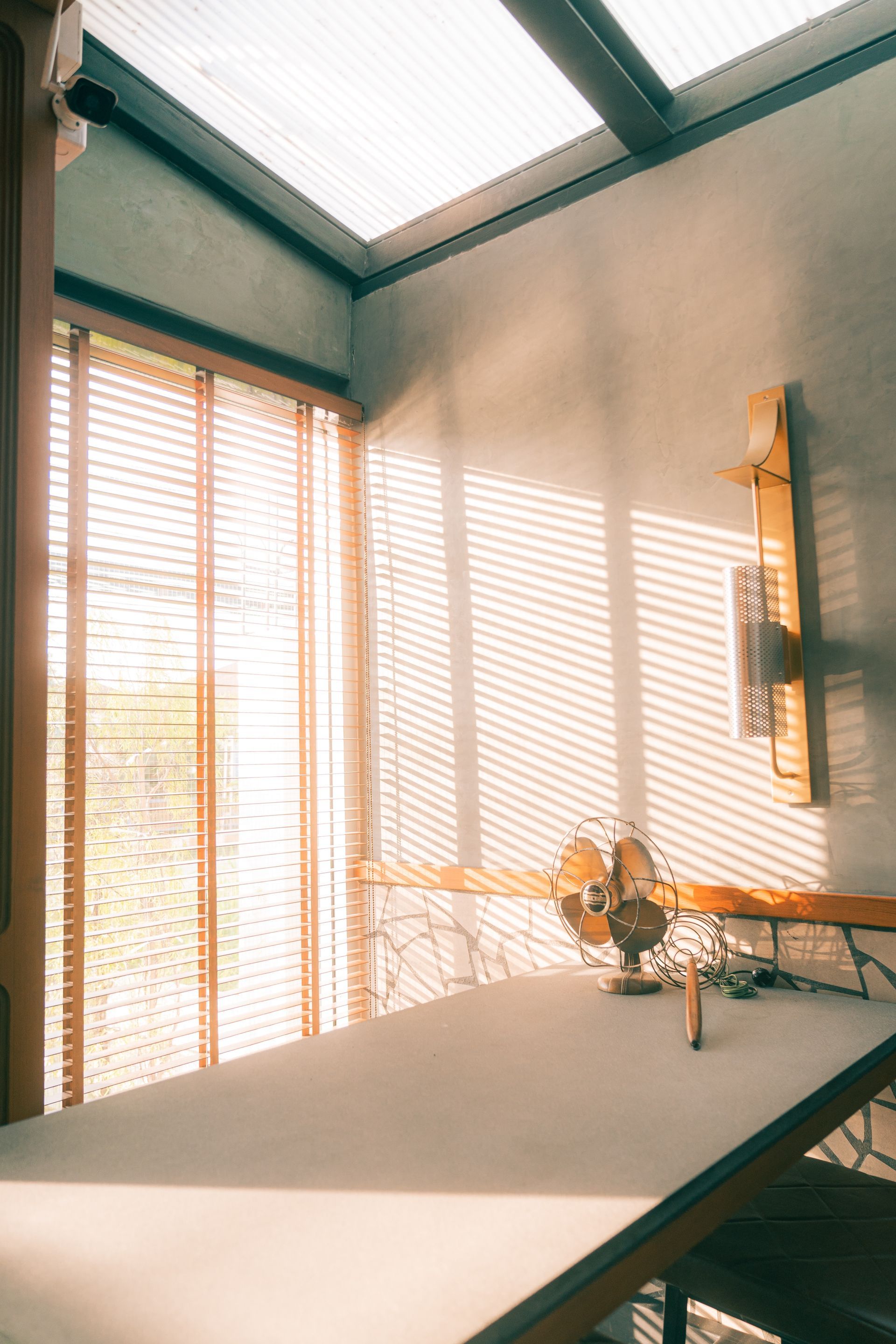 a room with a table and a fan in it