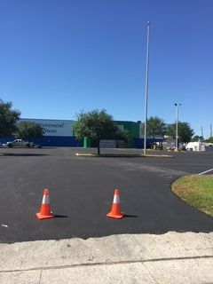 A construction worker is shoveling a hole in the road.