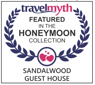 Travelmyth featured in the Honeymoon Collection badge for Sandalwood Guest House with blue laurel wreaths and pink heart icon