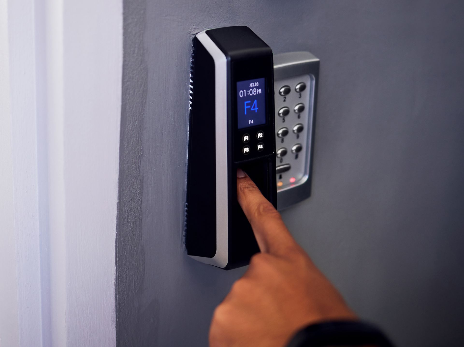 A person is using a fingerprint scanner on a door.