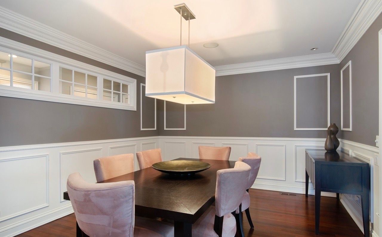 A dining room with a table and chairs and a chandelier