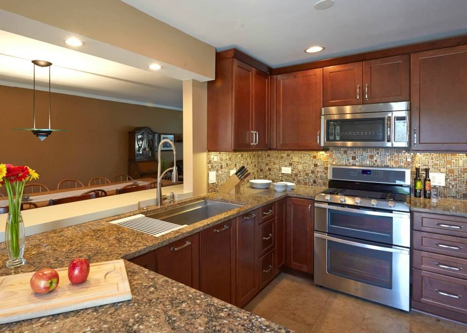A kitchen with stainless steel appliances and granite counter tops