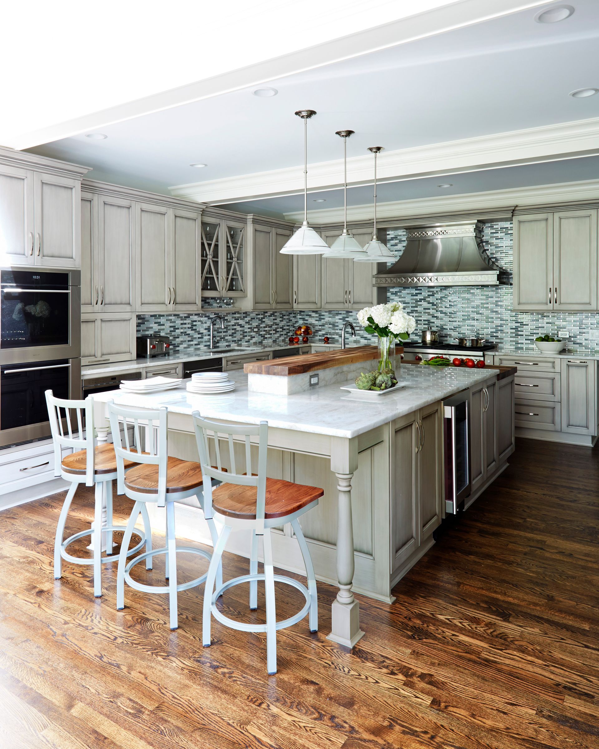 A kitchen with a large island and stools