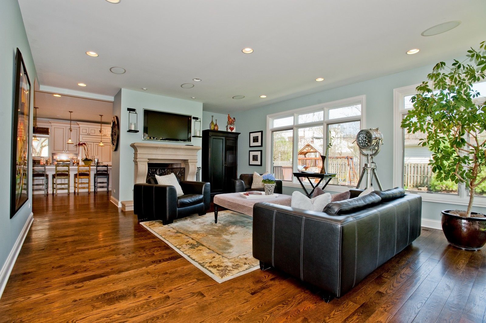 A living room with a couch , chairs , and a fireplace.