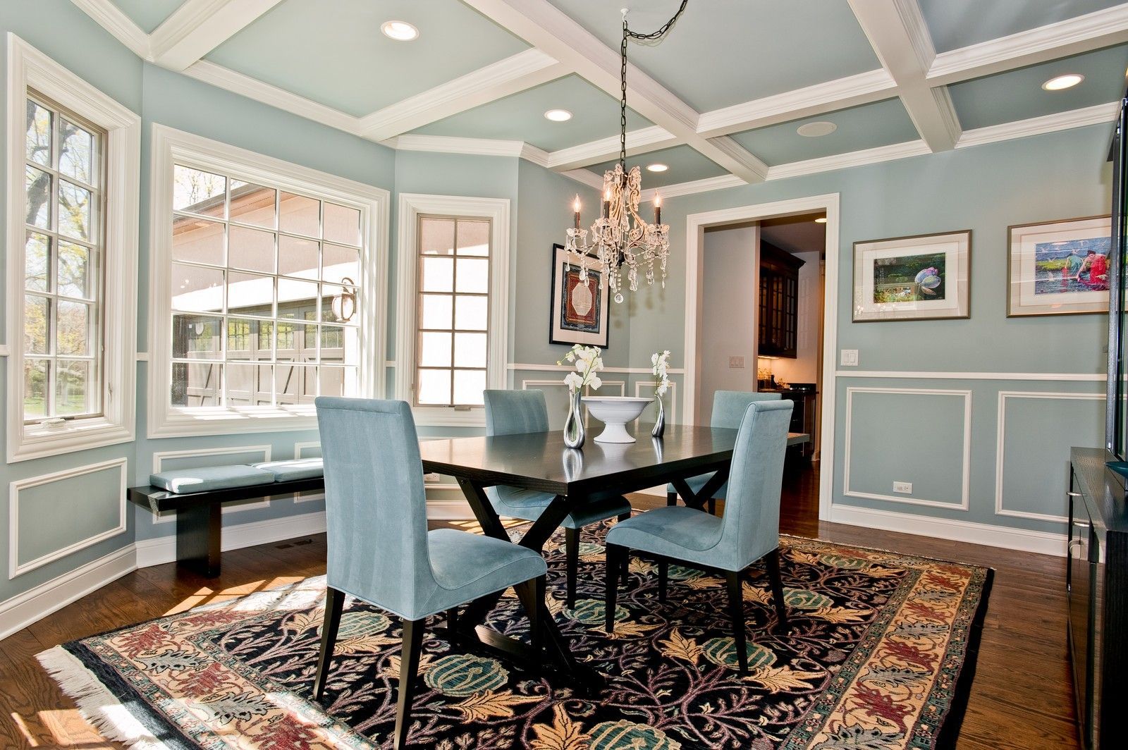 A dining room with a table and chairs and a rug
