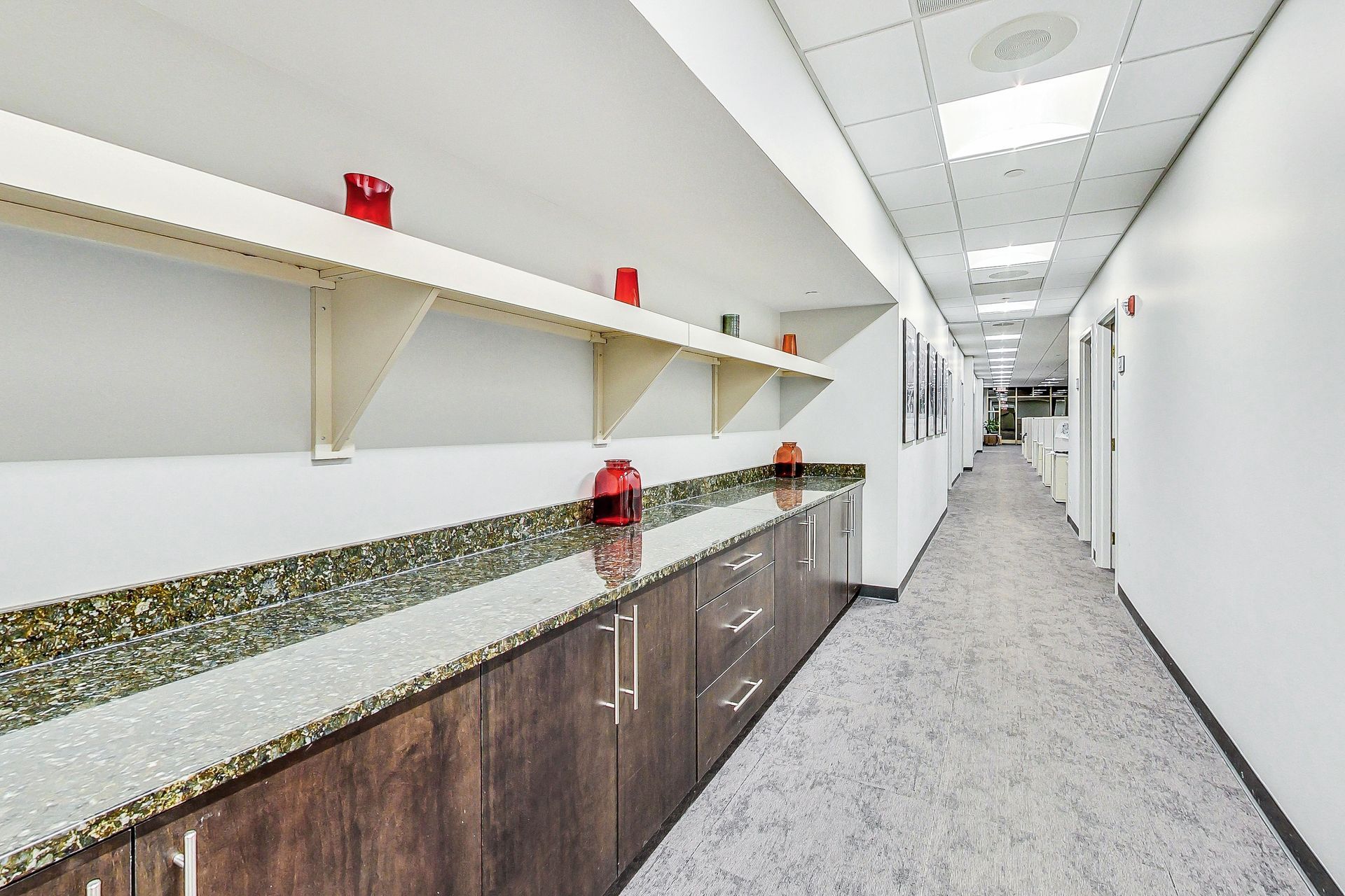 A long hallway with a lot of cabinets and shelves