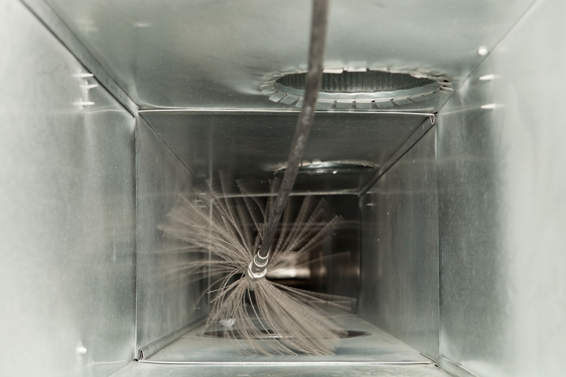A Close up Of a Duct with A Brush in It