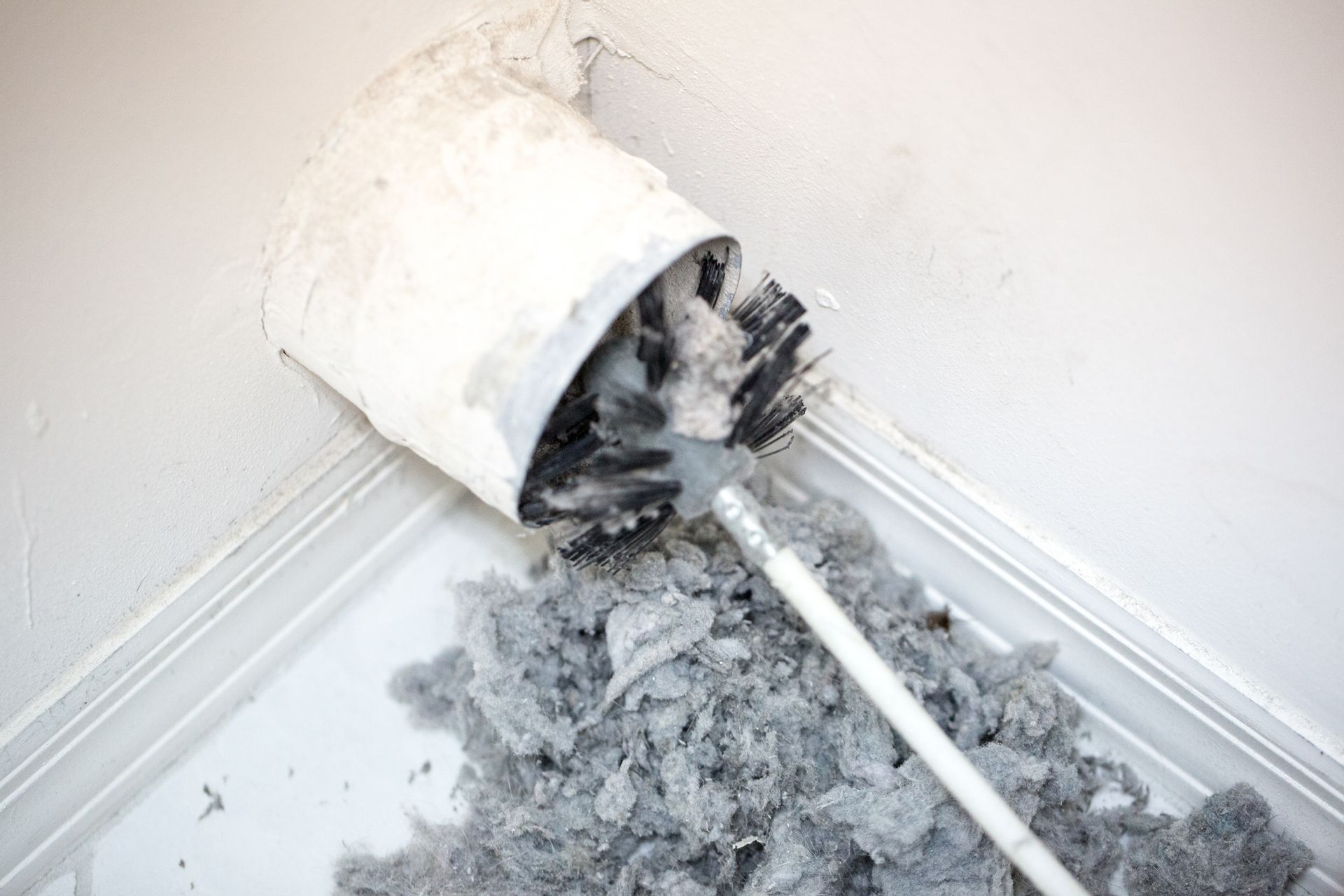 A Close up Of a Duct with A Brush in It
