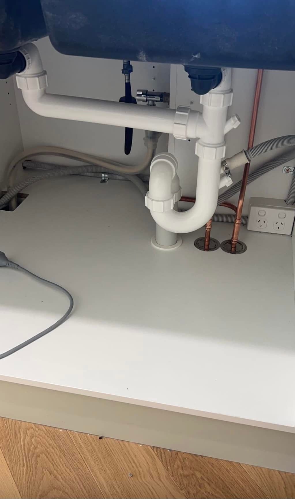 The Underside of a Sink With a Lot of Pipes Coming Out of It — Clinton McArthur Plumbing in Landsborough, QLD