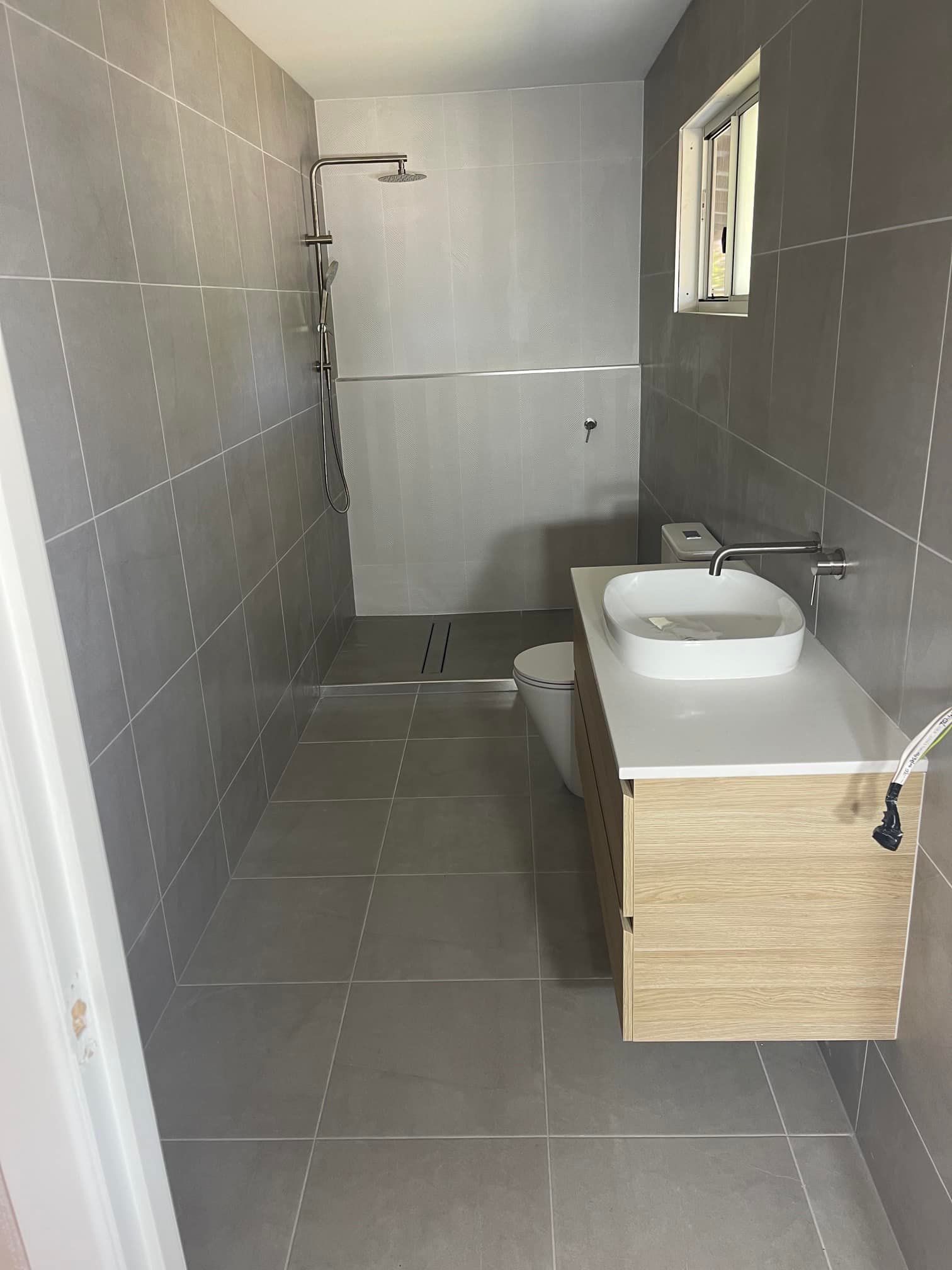 A Bathroom With a Sink, Toilet and Shower — Clinton McArthur Plumbing in Landsborough, QLD