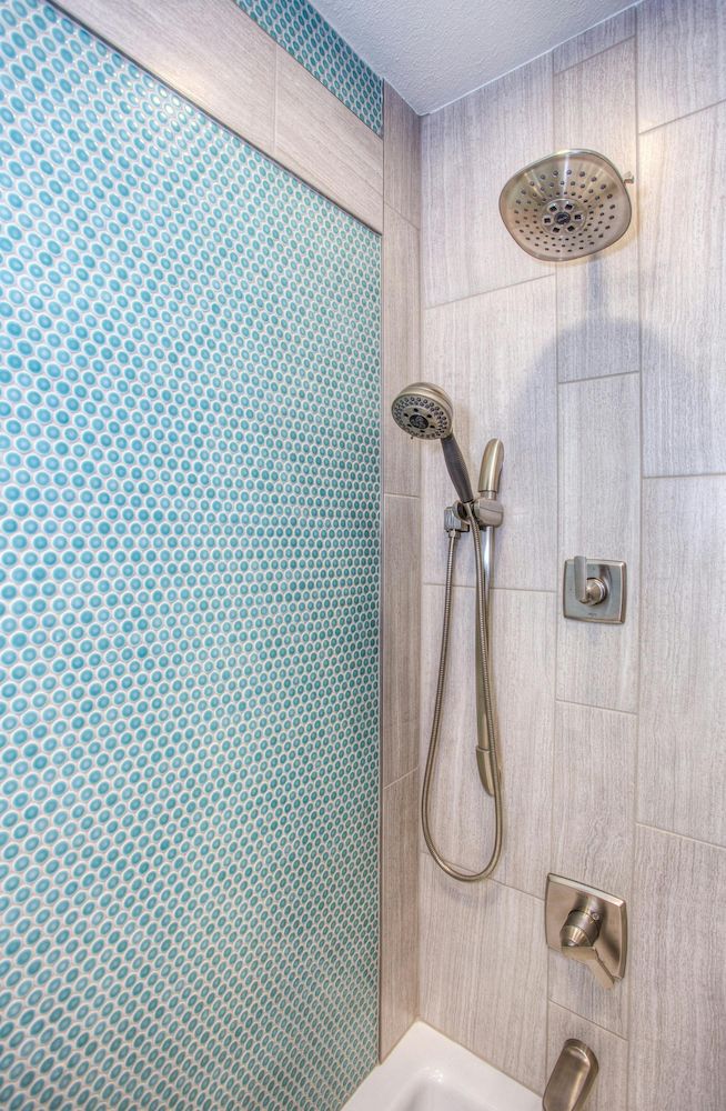 A Shower With a Blue Tile Wall and a Shower Head — Clinton McArthur Plumbing in Landsborough, QLD