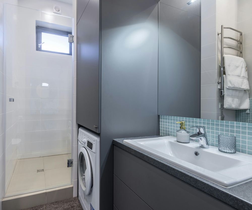 A Bathroom With a Sink , Washer and Dryer — Clinton McArthur Plumbing in Mooloolah Valley, QLD