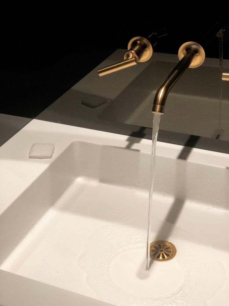 A Bathroom Sink With a Gold Faucet and Soap Dispenser — Clinton McArthur Plumbing in Glenview, QLD