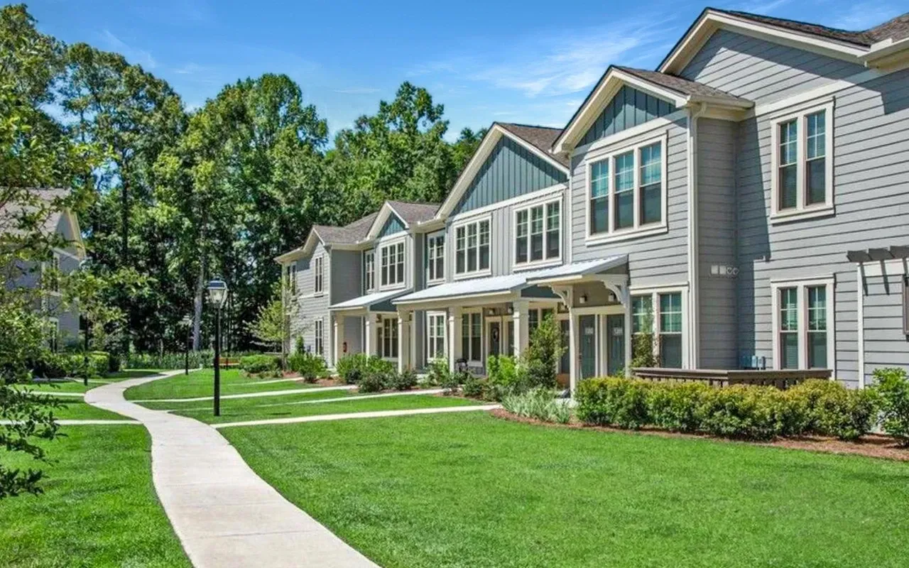 A row of houses with a sidewalk leading to them at The Preserve at Essex Farms, offers apartments in Charleston, SC.