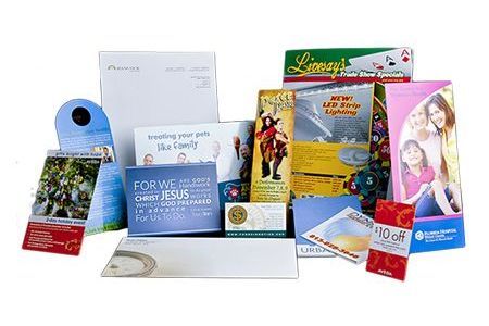 A bunch of cards and envelopes are sitting on top of each other on a table.