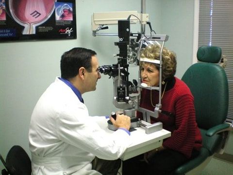 Dr. Kurt J. checking on female patients eyes — Laurinburg, NC — Laser Eye Institute PA Dr. Kurt J. checking on female patients eyes — Laurinburg, NC — Laser Eye Institute PA