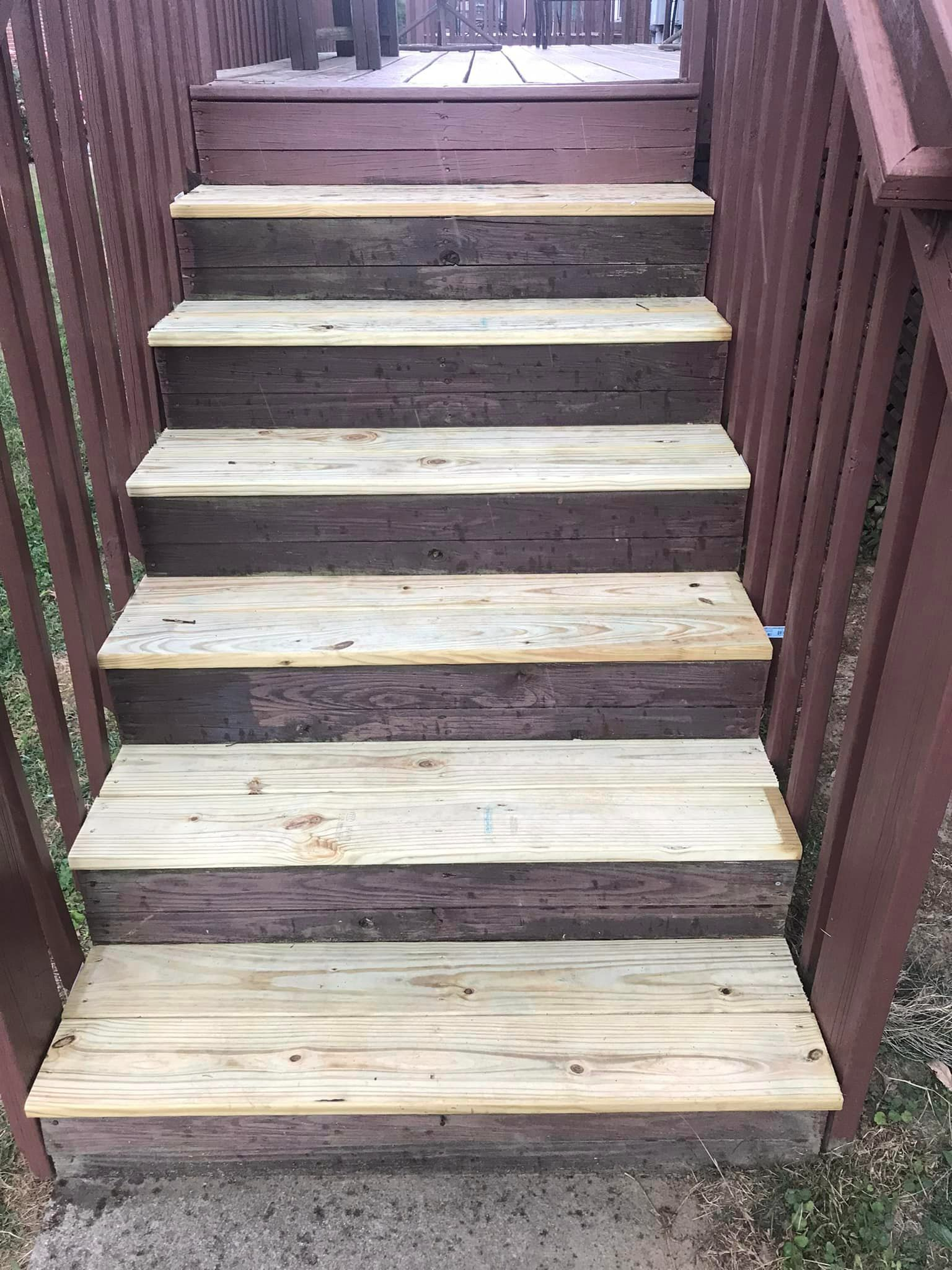 A set of wooden stairs leading up to a deck.