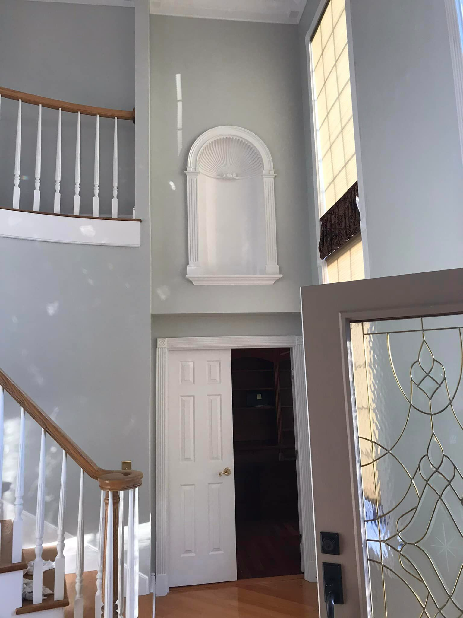 A hallway with stairs leading up to the second floor