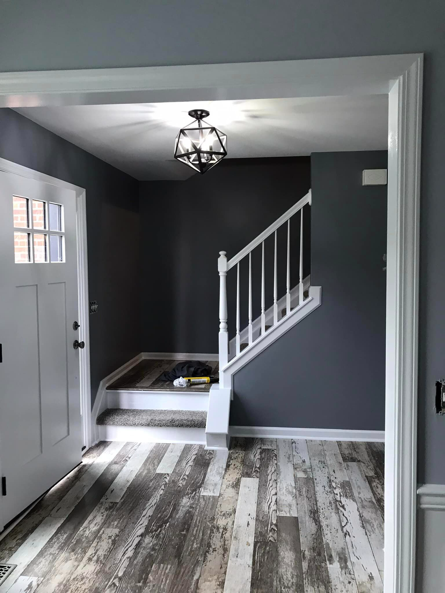 A hallway with stairs leading up to the second floor of a house.
