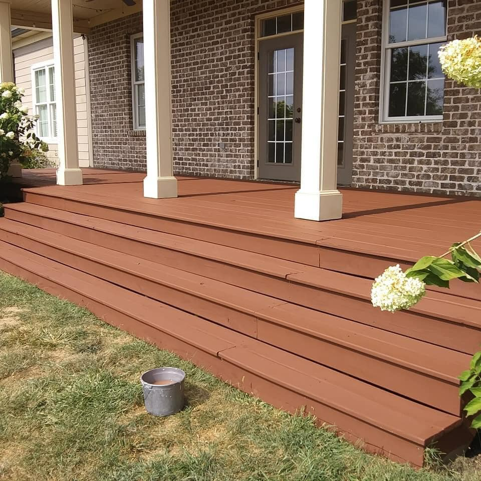A brick house with a wooden porch and steps